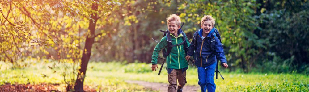 Two 6 year old school boys excited to return home after a day at school.  At home they will play sports, perform art at creative studio Creative You in Thalwil, and read their favorite stories.  