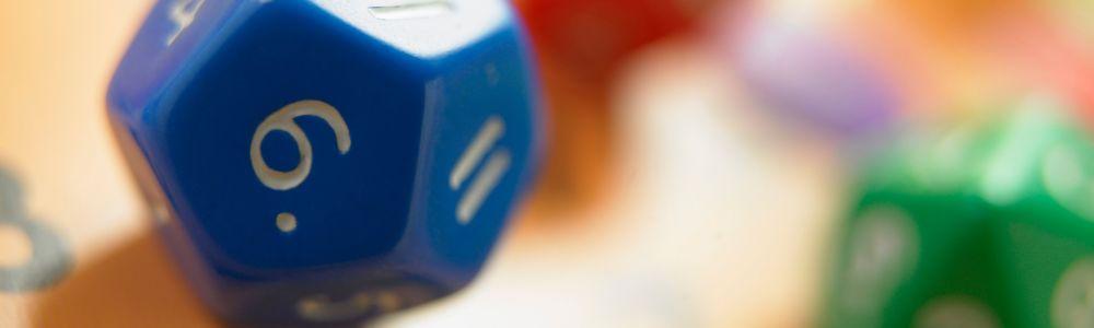 A picture of a blue octahedron dice among many other ones with different colors, arranged and ready for mathematical calculation training for school children and teens.  Calcularis is a mathematical training app that complements and re-enforces math class at school. 