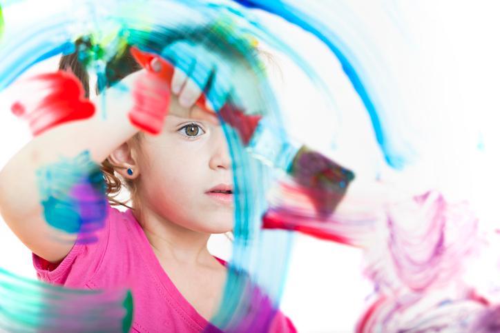 girl painting acrylic paint on glass