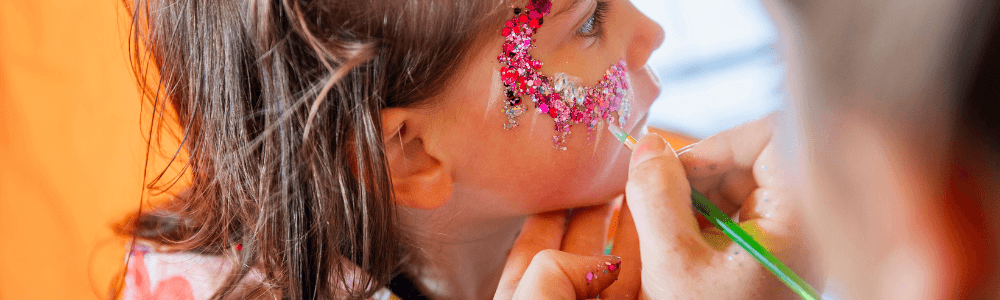 A young girl with glitter and facepainting at Derndrospito playground and party venue