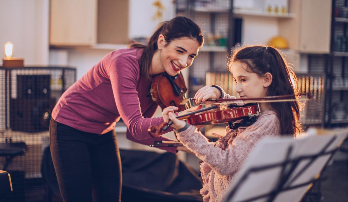 A private violin class with a young girl and her teacher