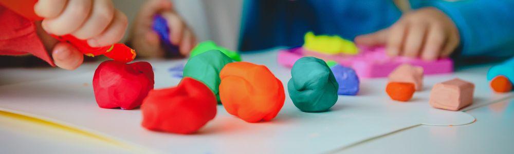 Balls of colorful and fluorescent playdoh at a children's workshop in Mikroi Iroes, a safe and fun day-care and playground for children in Holargos, Athens, Greece.  