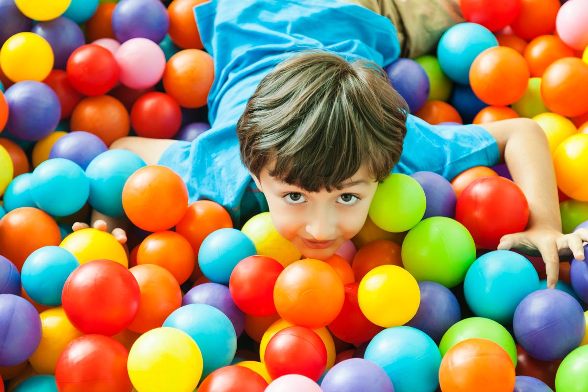 boy in ball pool indoor playground