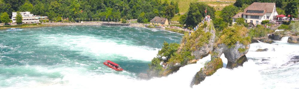 The view above over the Rheinfall near Schaffhausen, Switzerland.  One can see the red tourist boat carrying visitors to the rock in the center of the waterfalls.  An incredible experience for the whole family.  