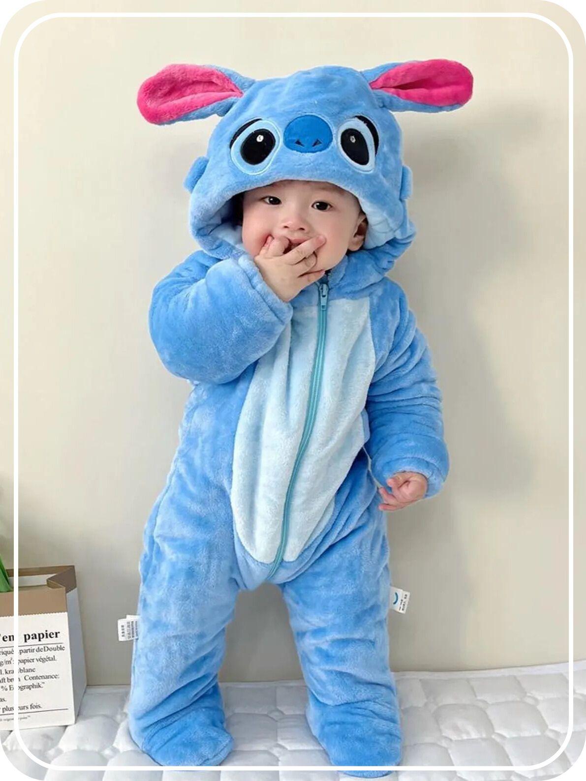 An asian toddler boy is wearing a cuddly Stitch onesie, fully dressed for a halloween party.  