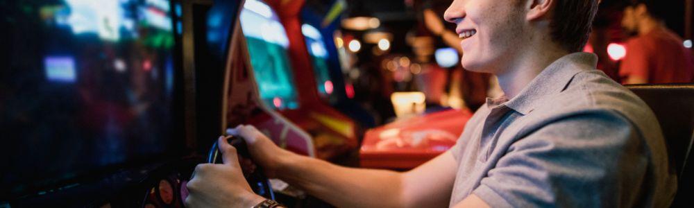 A teenage boy playing at the arcade of the Gameorama Interactive Museum in Luzern