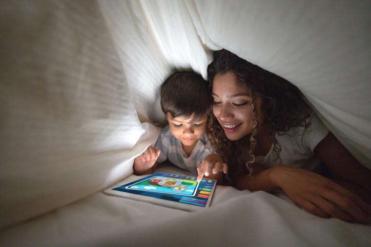 mom and son looking at table under the sheets