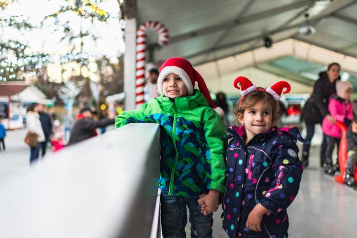 Children with santaclaus hat at the Zurich Christmas market ice skating rink