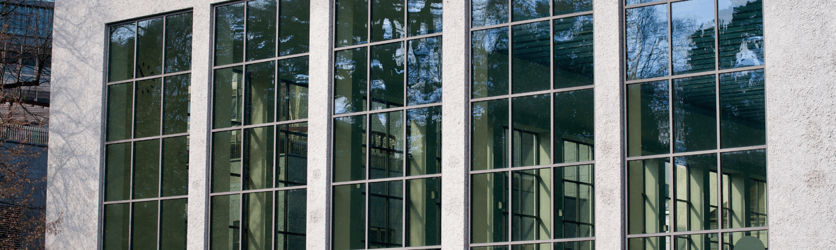 An outside view of the large windows of the Zurich City Hallenbad and Swimming facilities