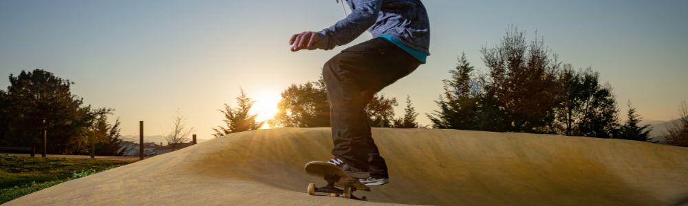 A teenage boy is enjoying the bike-park in Zurich during sunset, a great place for kids to spend the day with their bike, skateboard or scooters.  