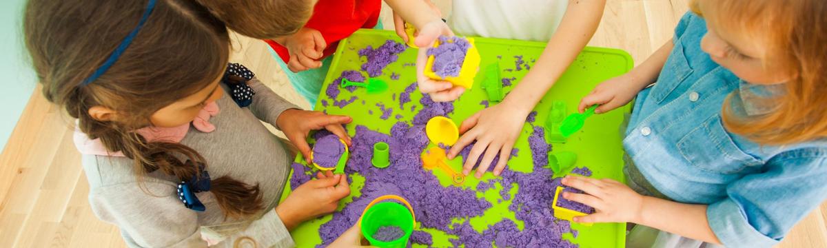Children engaged in hands-on learning activities at Cleverkidz, using educational toys and materials in a bright, playful classroom setting.”