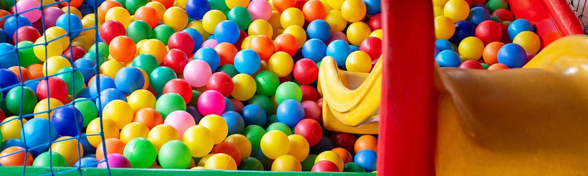 Colorful play area with themed decorations and fun activities designed for young children, featuring toys, games, and creative setups in a cheerful environment.
