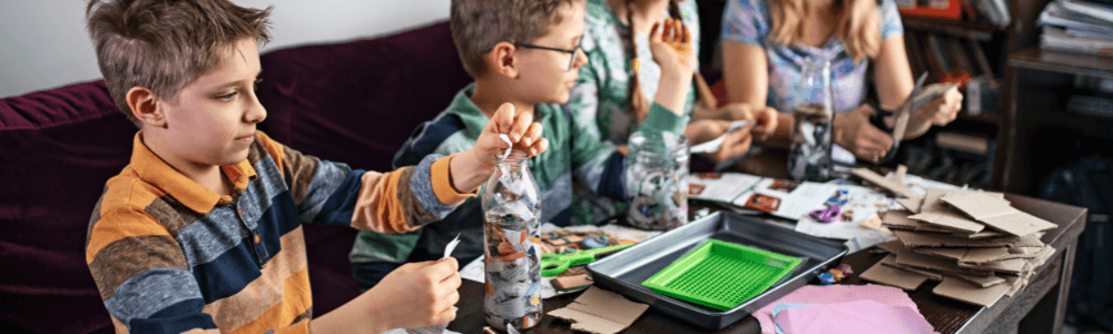 Young boys making paper mache and crafts at a birthday party in Moto Moto in Athens