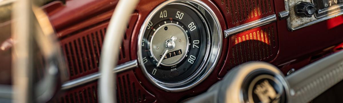 An image of a vintage speedometer behind the wheel of a historic car at the Hellenic Motor Museum in the heart of Athens, where children and families can admire cars from different periods in history.  It is also a place to host birthdays and events for kids.  