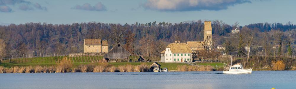 A photo from a distance of the Island Ufenau in Lake Zurich.  it is resided by monks and and is a great day trip in spring and summer with kids with lots of nature to explore.  