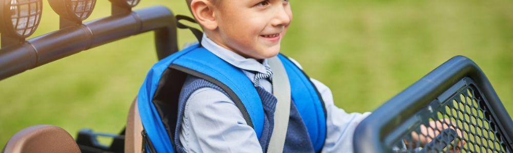 A young boy between 7 and 10 years old training as a driver at Jumicar Driving Park in Nea Makri in Athens Greece.  He is buckled-up in a gasoline powered child-sized car ideal for learning the fundamentals of correct driving behavior. 