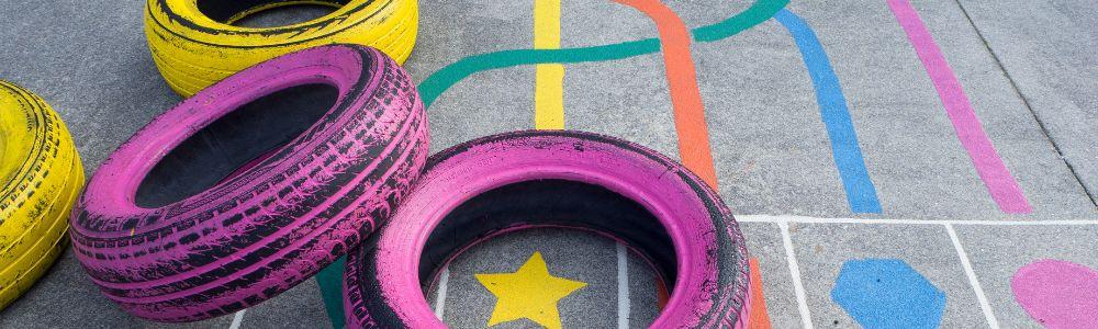 Painted tyres and a painted floor at Kado Paradiso, a playground and creative workshop area for children made from up-cycled materials, in Kato Petralona, next to the Pavlidis Chocolate Factory, in Athens, Greece.