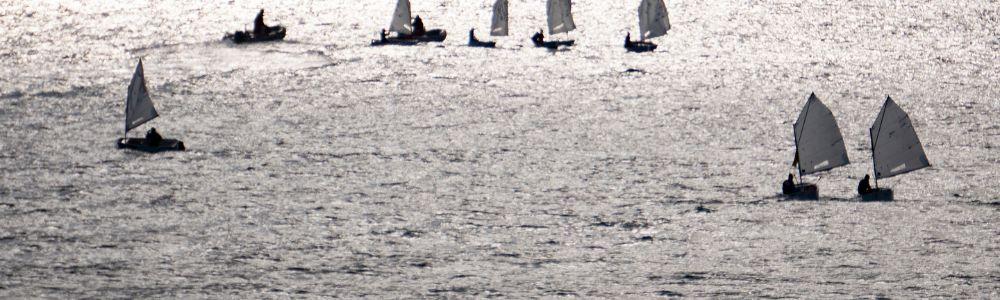 A class of optimist boats sailing in the Aegean Sea, as part of group sailing classes for kids at the Sailing Club of Palaio Faliori, in Athens, Greece.