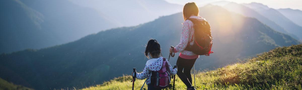 Hikers traversing a scenic trail on Mount Rigi, overlooking Lake Lucerne and the surrounding Swiss countryside.