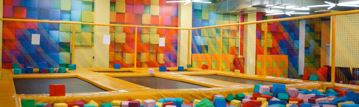 Vibrant spring-themed play event with children participating in games, crafts, and outdoor fun surrounded by flowers, pastel decorations, and cheerful atmosphere.