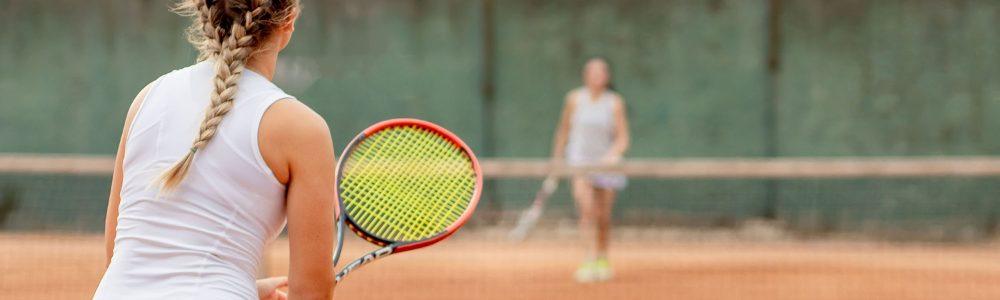 A tennis match between two teen girls in Baar, under the supervision of tennis coach Evan Bolofis in Baar, Switzerland