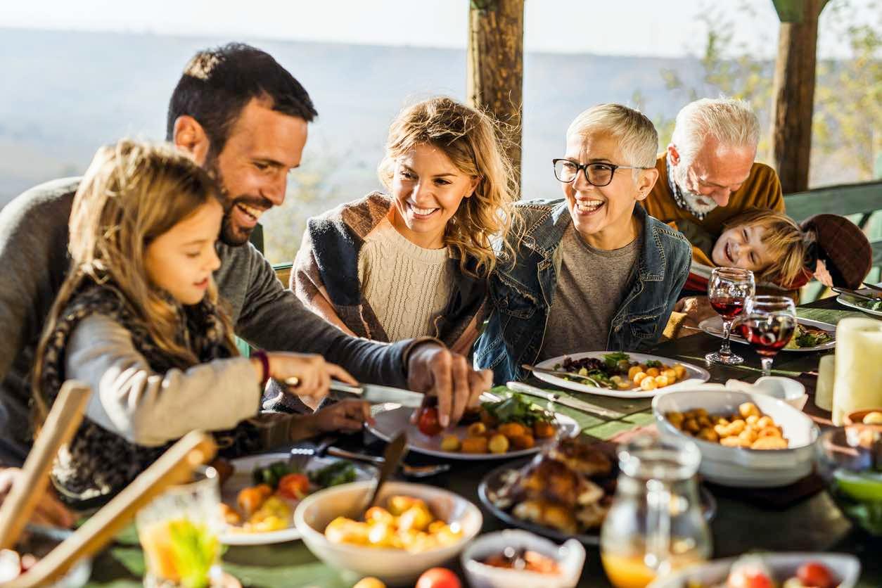 A family gathering of three generations at an outdoor restaurant near Zurich, Switzlerand.  Children parents and gradparents all together enjoying a relaxed family meal.