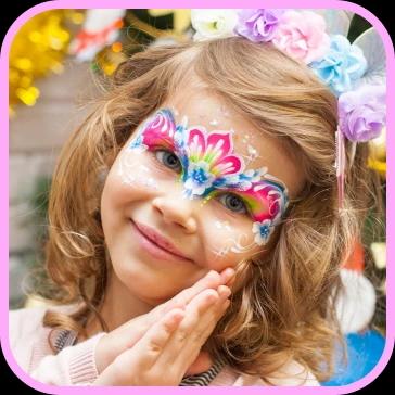 Face painting with fuchsia pink and blue on the face of a young girl dressed up for a children's birthday party in Zurich or Zug, the creator of the facepainting is Bloomart.  