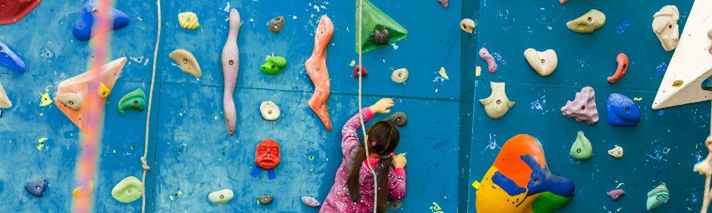 A young girl on the climbing wall at the indoor playground and trampoline center Magic Land in Anoixi, in Athens, Greece.