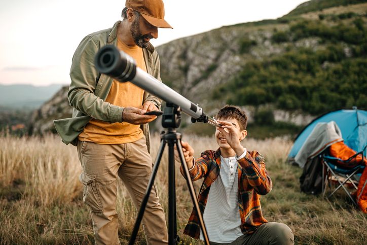 dad and teen telescope outdoor camping